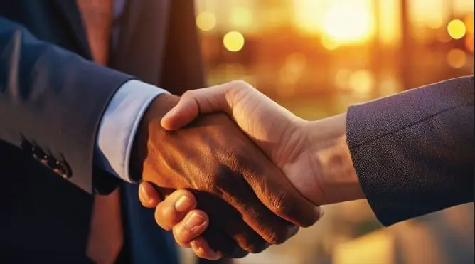 Two people shaking hands on a new working partnership